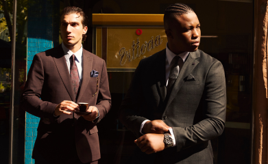 Blog tile thumbnail for POLITIX AW25 featuring two men in tailored suits outside a Melbourne café.